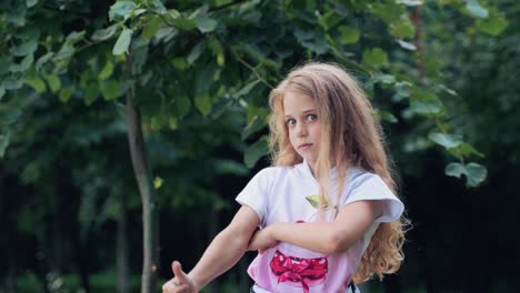 sad emotions of a child girl. a smile on the face and a sign of approval with a thumbs up hand