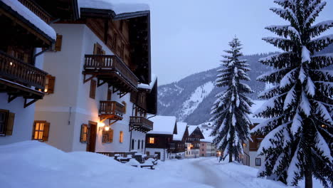 snowy alpine village at dusk