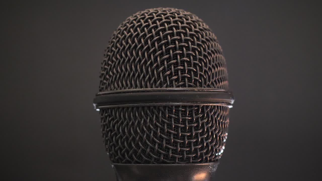 Extreme closeup of old dirty stereo microphone head, spinning. Macro shot.  Scene J.