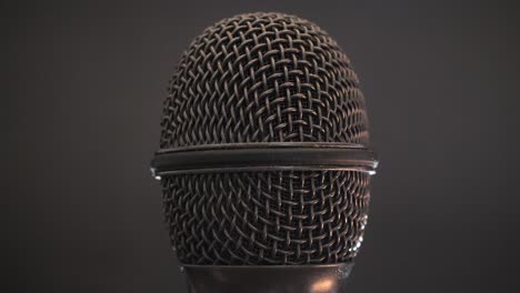extreme closeup of old dirty stereo microphone head, spinning. macro shot.  scene j.