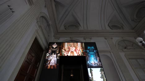 tilt up view of room inside palazzo reale, milan, during high fashion art exhibit