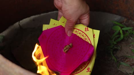 lighting and burning joss paper in a ritual