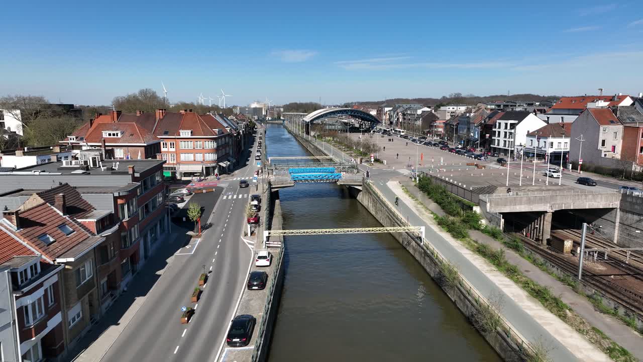 Aerial zoom in above canal and residential streets in Brussels, Belgium, with modern and traditional architecture