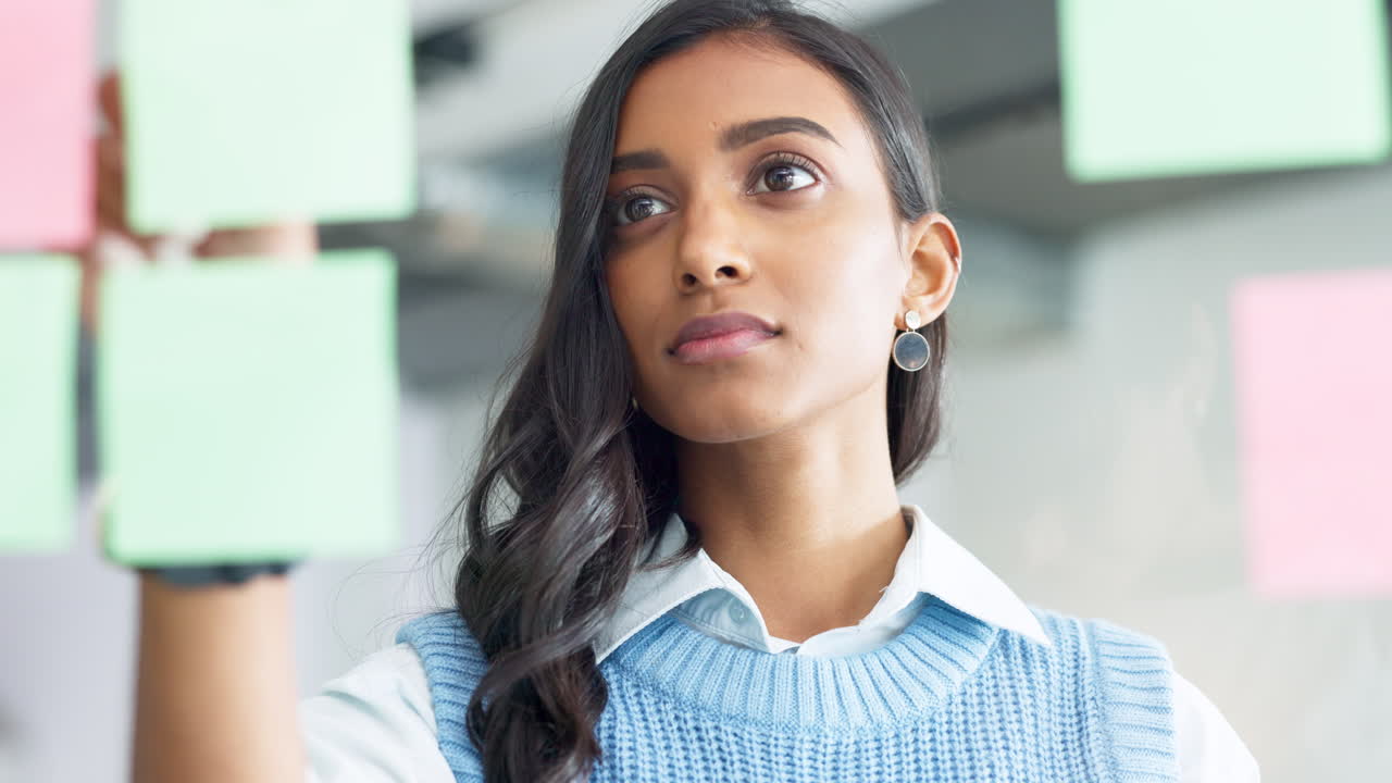 Focused young business woman thinking