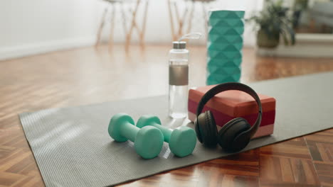 dumbbells, floor and water bottle in living room