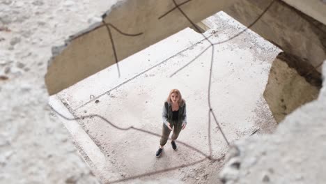 a beautiful woman singing about ukraine in the middle of the ruins of bombed buildings