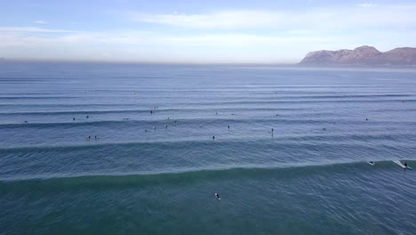 Aerial-Footage-of-surfers-in-sea-in-South-Africa,Muizenberg