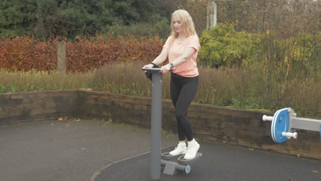 Athletic-woman-exercising-using-resistance-stepper-in-park