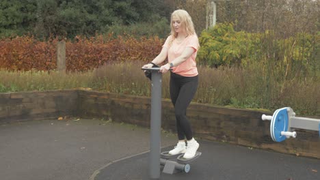 athletic woman exercising using resistance stepper in park