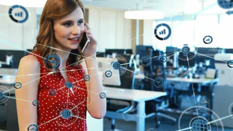 Animation-of-connected-icons-over-beautiful-caucasian-woman-talking-on-cellphone-at-office