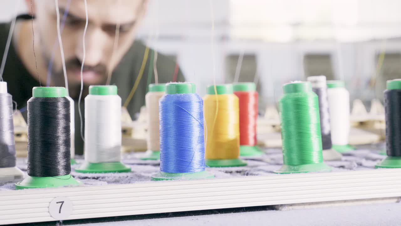Man in sewing factory checking the equipment