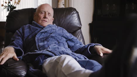 elderly man relaxing in armchair
