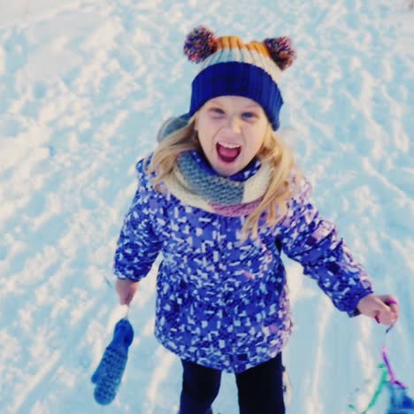 girl 5 years enjoys winter - throws snow 1