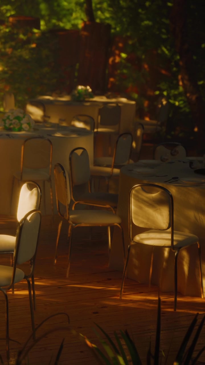 Tables and chairs set up for event in outdoor area at sunset