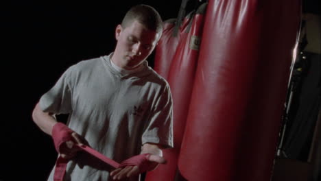 a boxer wraps his hands with tape as protection