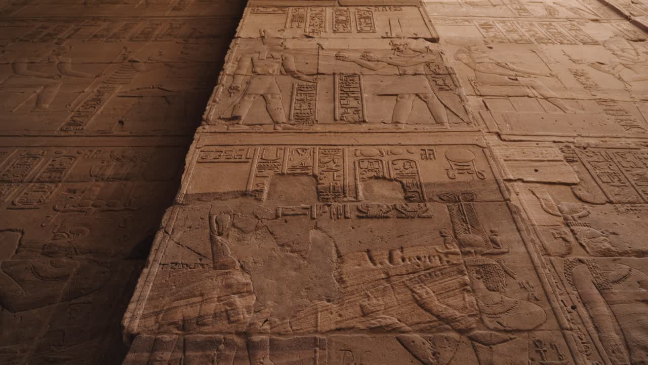 Interior wall of an Ancient Egyptian temple with relief sculptures depicting mythology