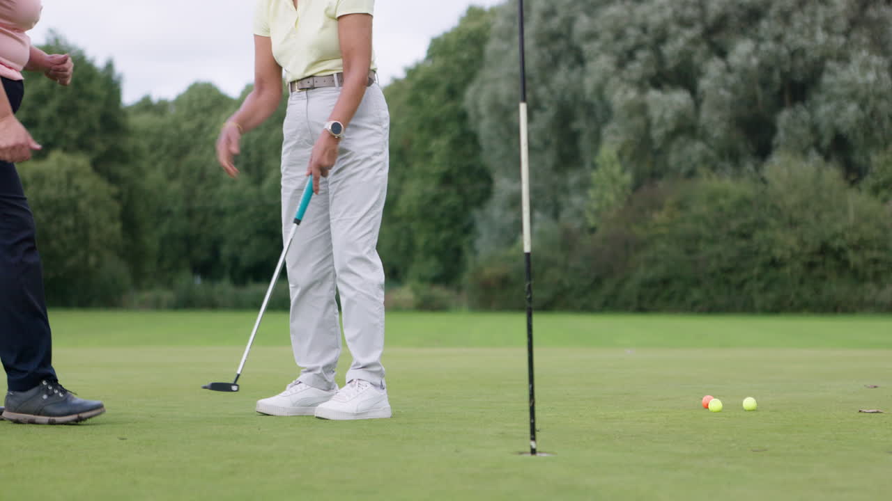 A golfer putting on the green