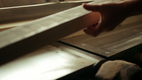 carpenter preparing wooden plank for product indoor