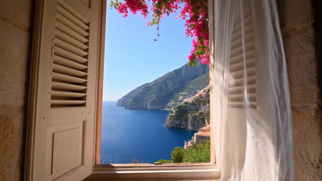 panoramic coastal view from a window with bougainvillea