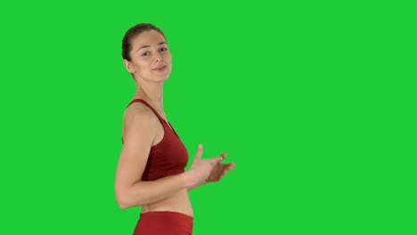 yoga teacher walking and explaining on a green screen, chroma key
