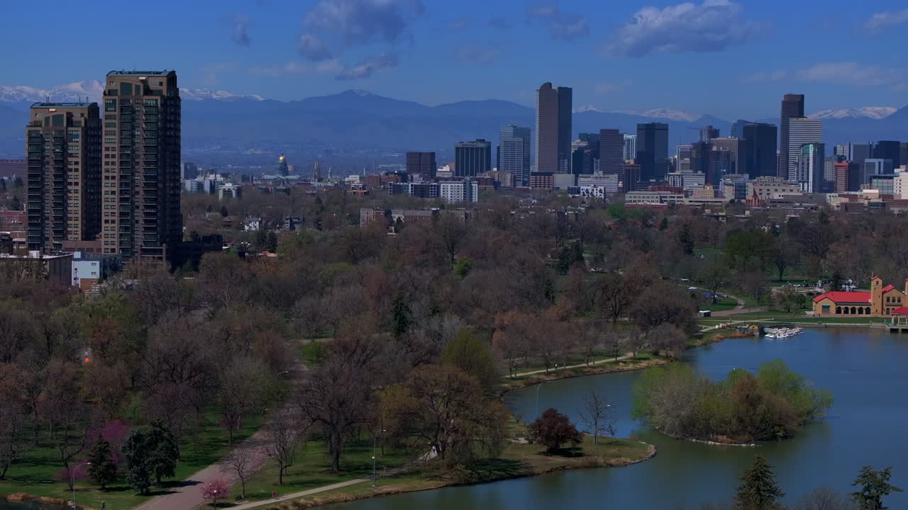 Downtown Denver City Park Colorado aerial drone Pavillon springtime summer tree wildflower blossom sunny morning blue sky Ferril Duck Lake bike walking path tall buildings skyscrapers pan right motion