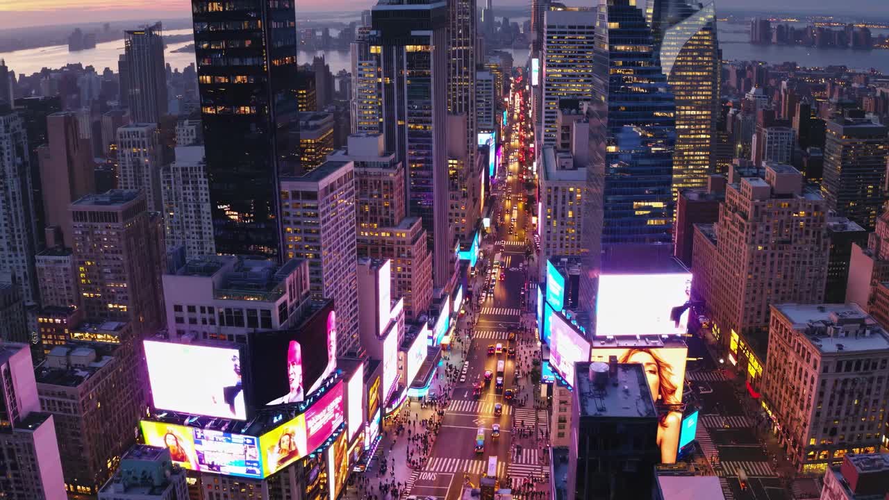 Aerial view of a bustling cityscape at dusk, showcasing vibrant lights and skyscrapers, reminiscent