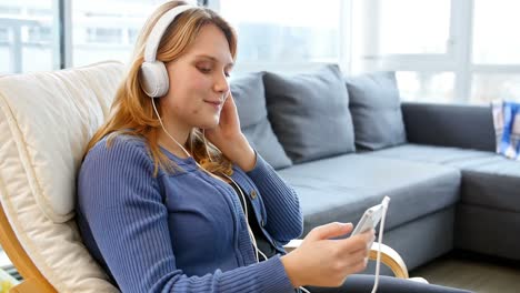 woman listening music on mobile phone