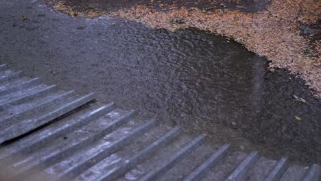 las gotas de lluvia fluyen hacia abajo, caen del techo en un charco durante la lluvia torrencial. 4k