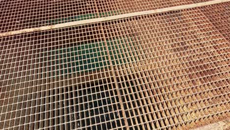 a metal grate with water visible below