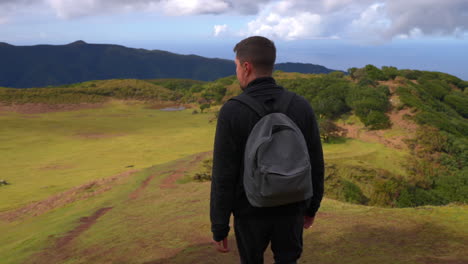 man hiking in a scenic mountain valley