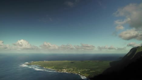 Time-lapse-of-clouds-over-a-mountaintop-and-beach-on-a-tropical-island