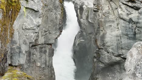 Slow-motion-tilt-down-shot-of-powerful-waterfall