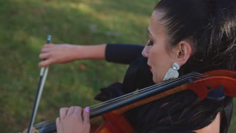 cellist playing cello outdoors