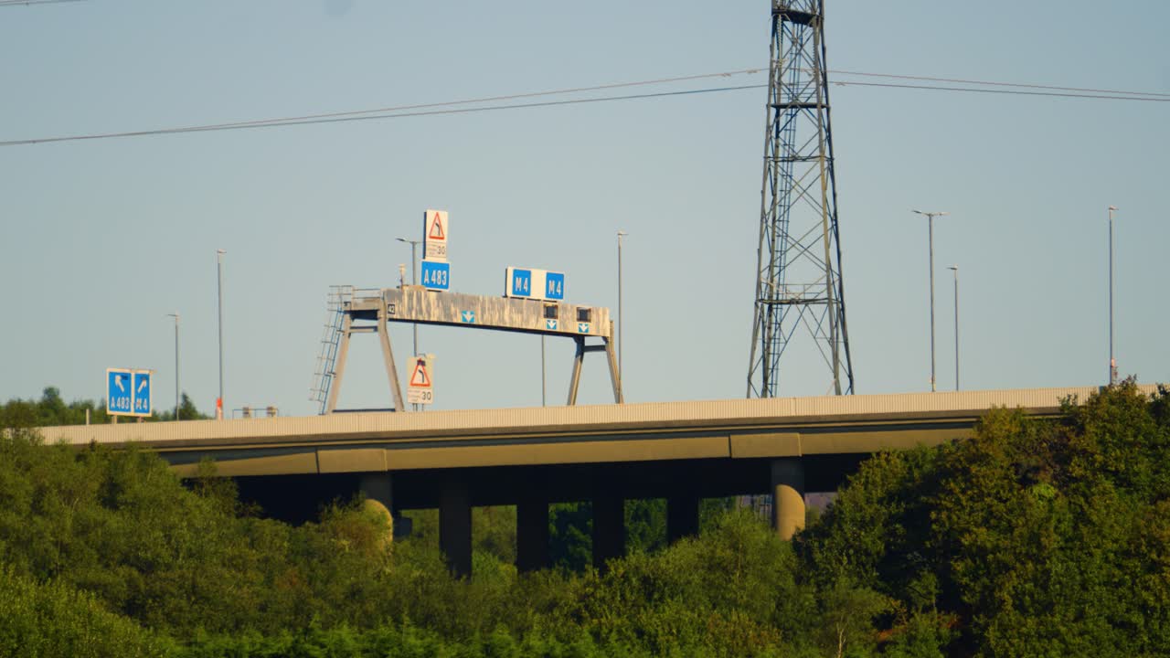 M4 Motorway Overpass Bridge at Junction 42 Fabian Way with Electricity Pylons with Trees Below