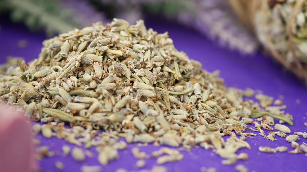 Pile of Dried Lavender Flowers on Purple Background