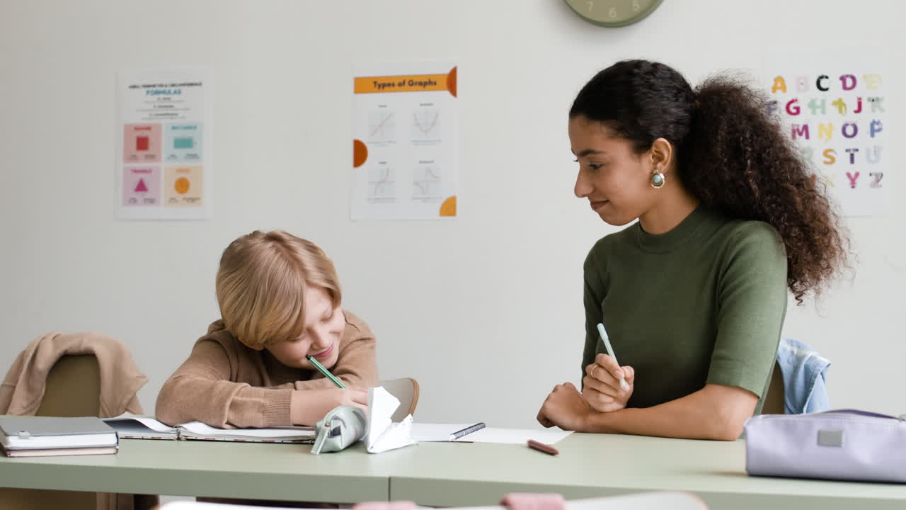 Student learning with teacher in a classroom