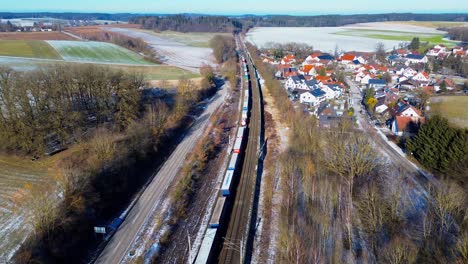 winter train route beside frost-covered village homes