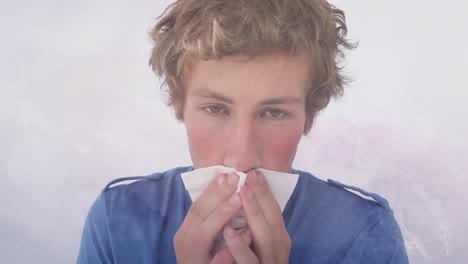 Animation-of-ill-man-sneezing-into-tissue,-over-misty-winter-background