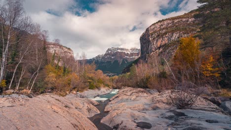 river in ordesa national park mondarruego mountain timelapse in fall autumn season in a beautiful cloudy autumn morning