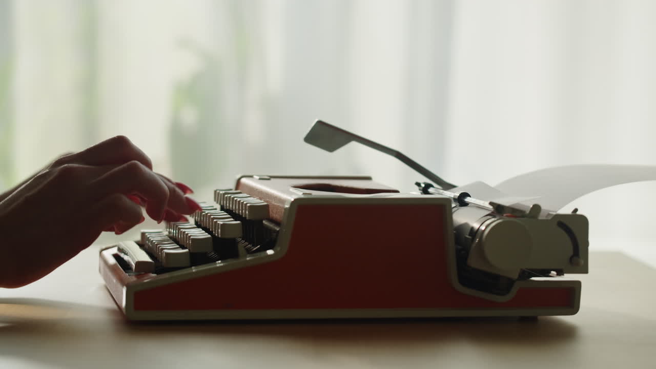 Woman Typing on a Vintage Typewriter