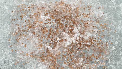 buckwheat falling into a pot of boiling water making a splash in slow motion, table top view