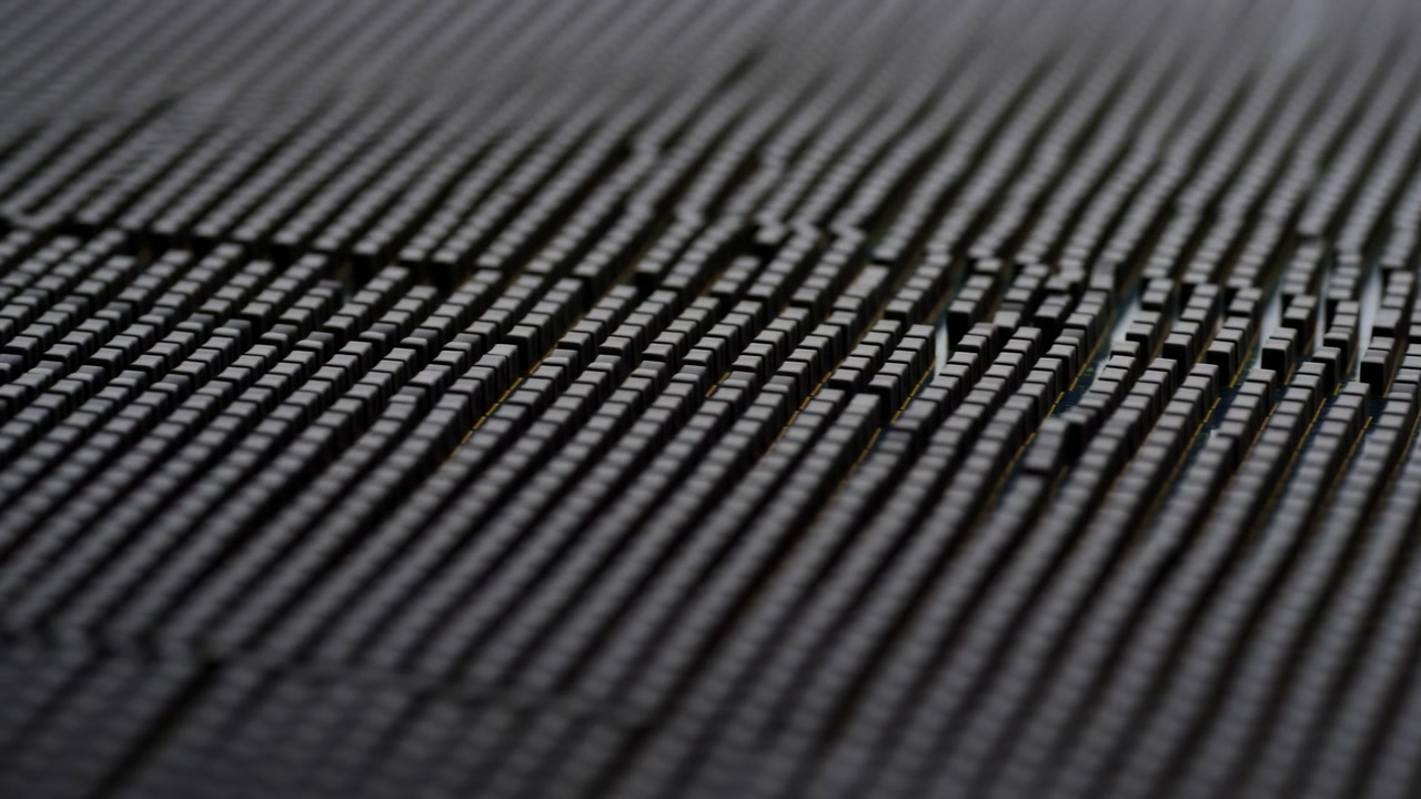 Close-up study of black plastic grid panel with shifting focus across repetitive ridges at