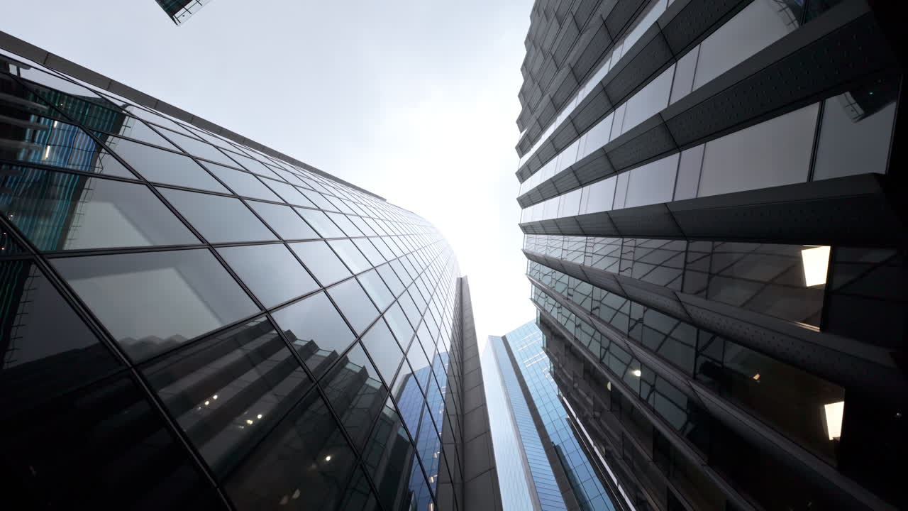 Skyscrapers in London's financial district reaching towards cloudy sky