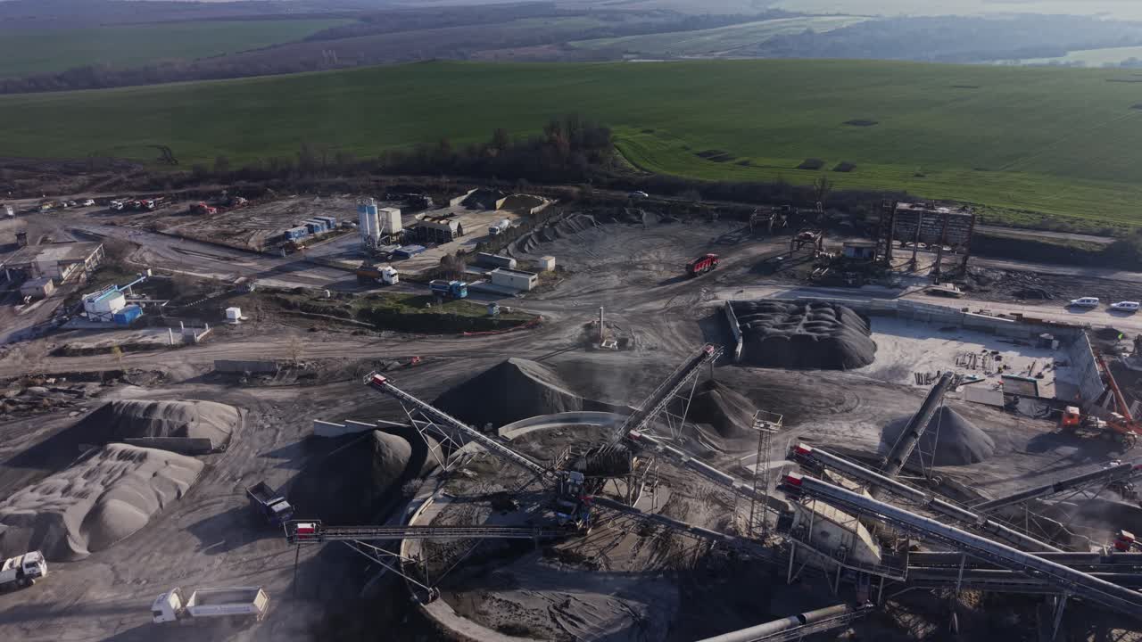 Mining operation takes place at quarry site during daytime in rural area