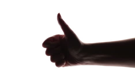 silhouette of woman hand giving thumb up on white background