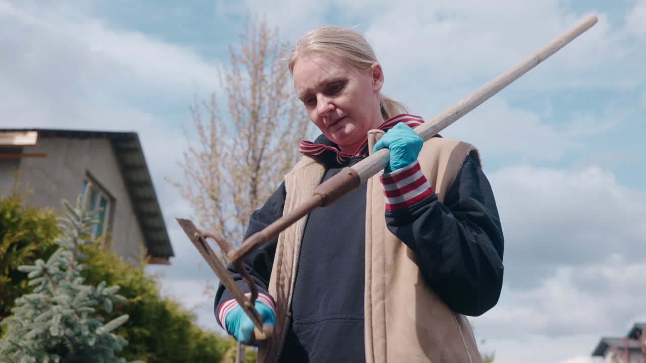 Woman gardening with a hoe