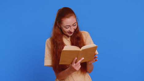redhead adult woman reading funny interesting fairytale story book leisure hobby learning study