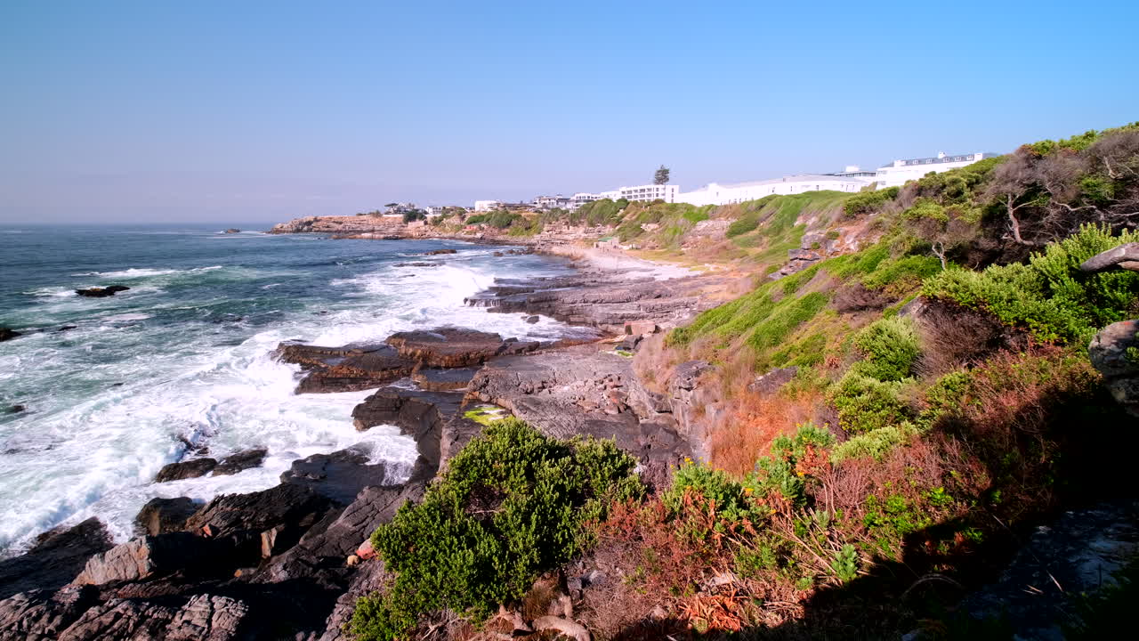Waves crash onto rugged coastline of seaside resort Hermanus in Overstrand