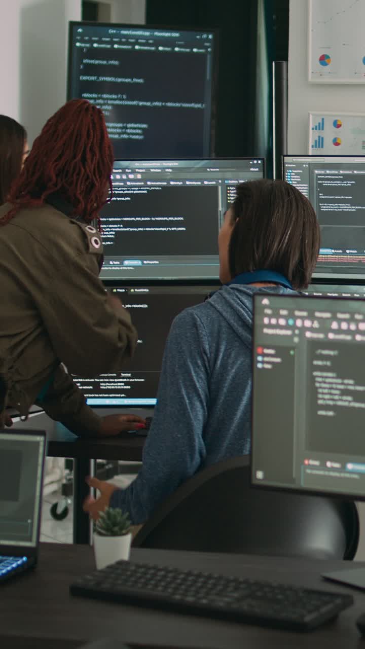 Vertical video: Database admins collaborating on group project compiling algorithm