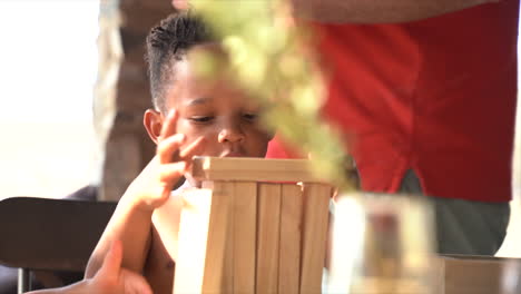 south african child playing with building blocks then they fall over all he laughs very cute